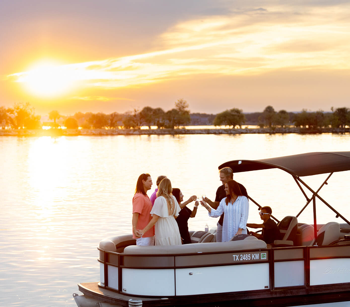 members on boat at sunset